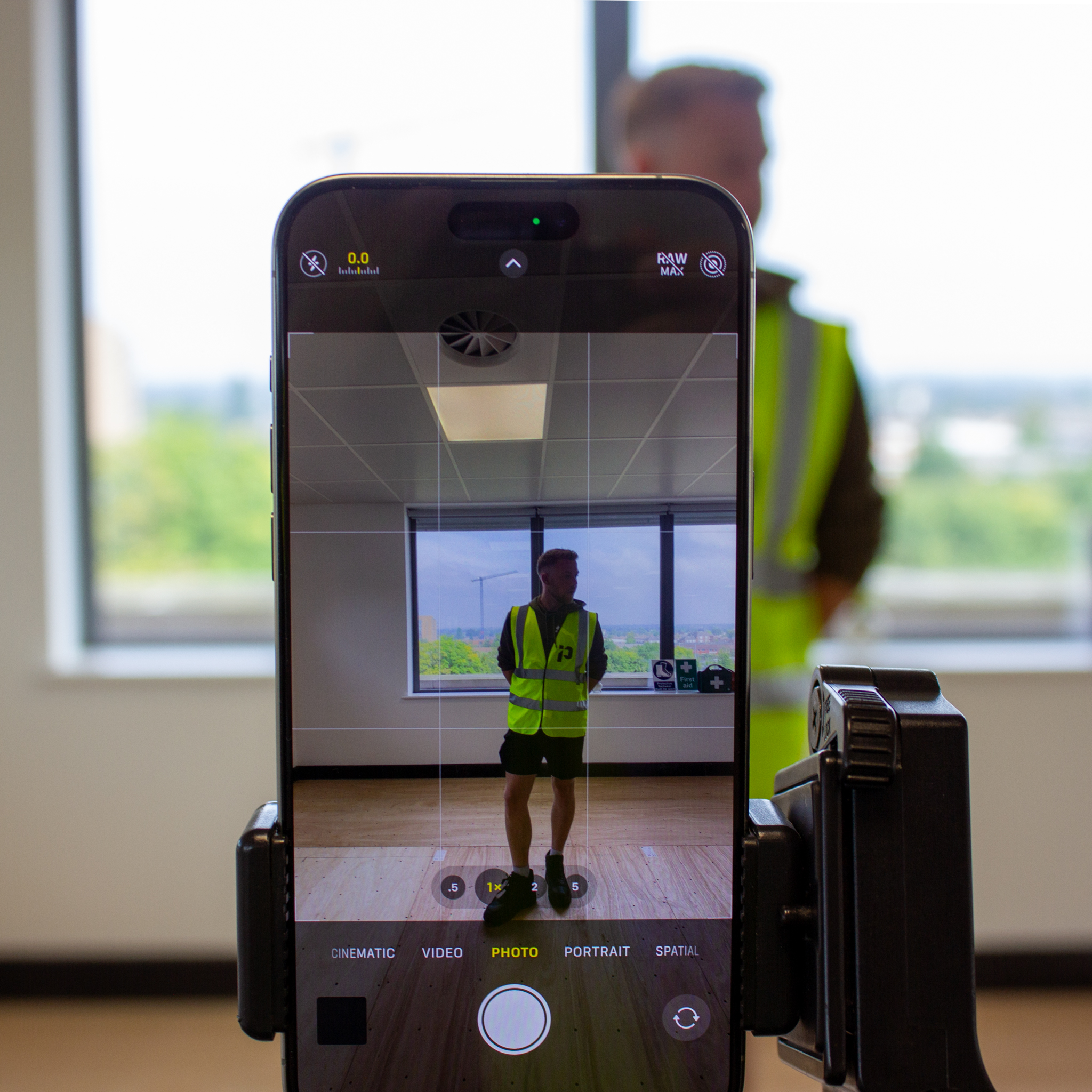 Phone on a tripod filming a worker